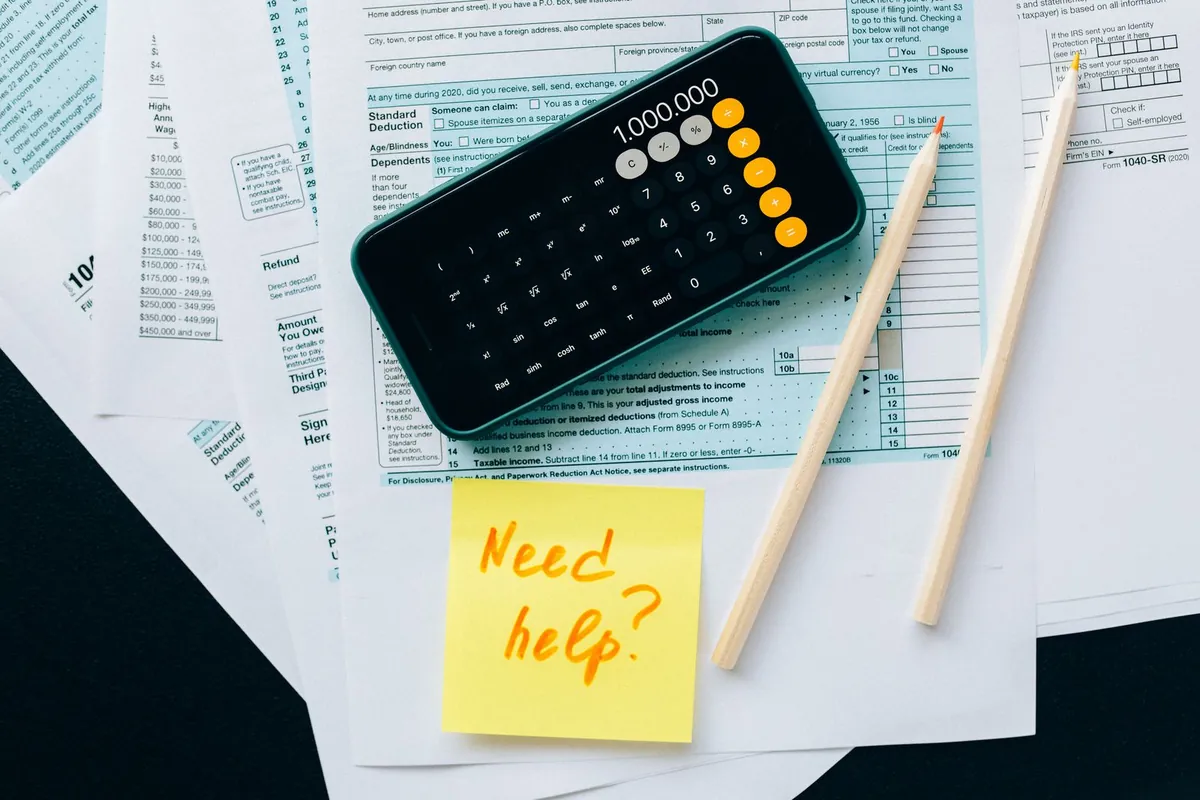 Fitting an Internal Assistant Into the Firm's Automation Roadmap Financial papers with a calculator and a note asking for help, fitting the assistant into the firm