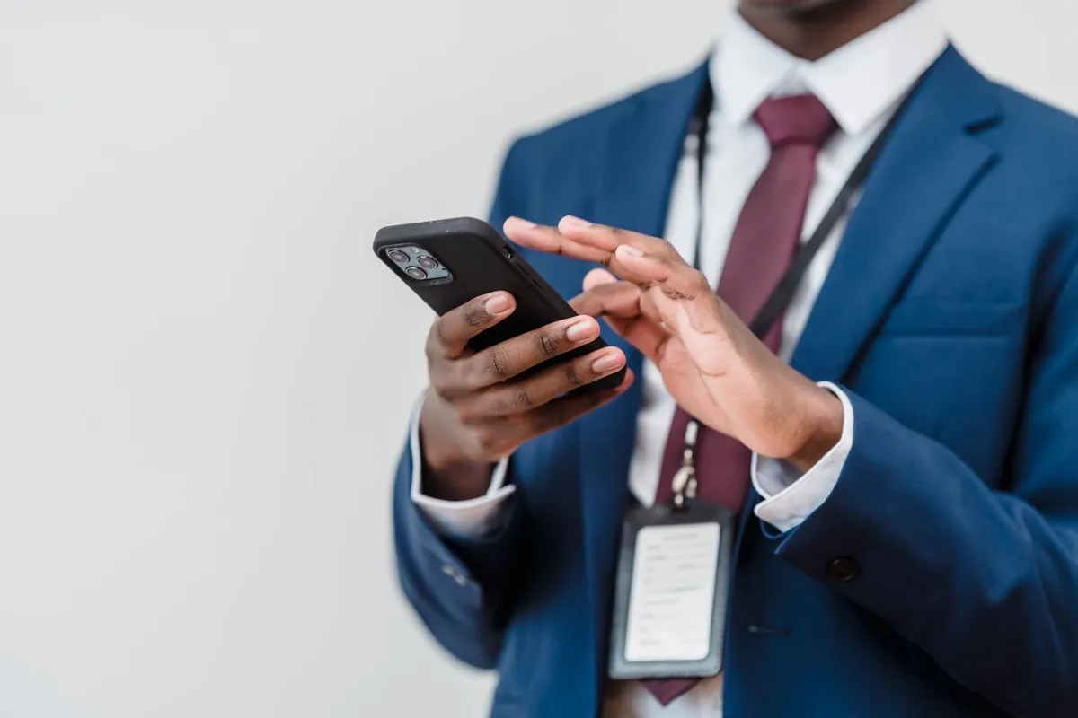 Businessman reading a message on his phone, what the text back should say