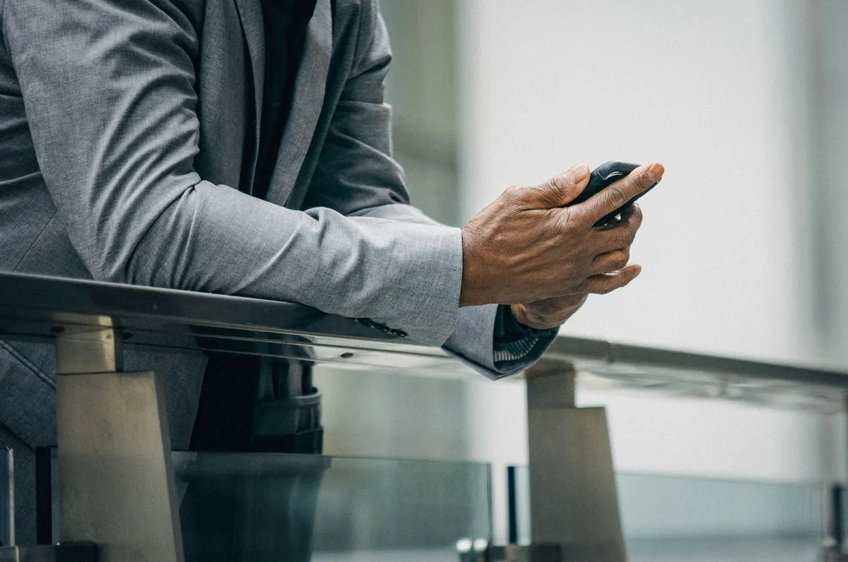 Meta Business Agent vs a Custom-Built WhatsApp AI Agent Businessman holding a smartphone, a business messaging agent against a custom build