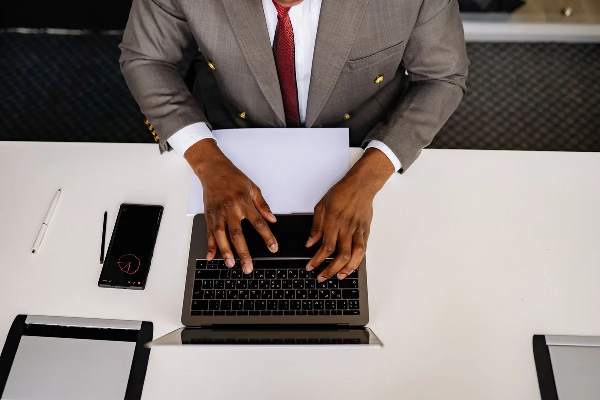 Controlling When and Where Your AI Agent Replies Businessman typing on a laptop, controlling when and where your agent replies